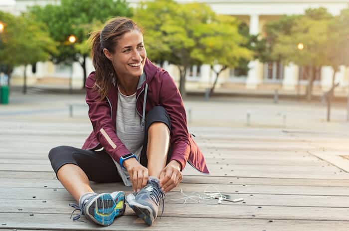 woman ties her running sneakers