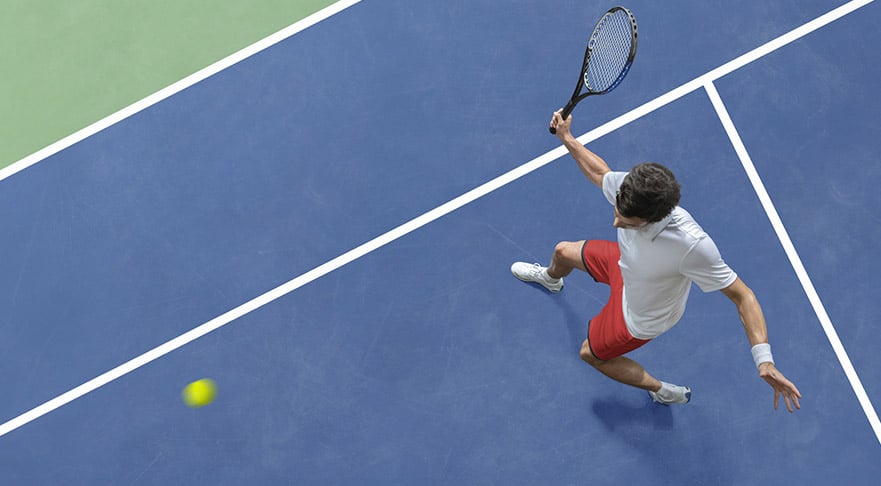 man makes tennis swing